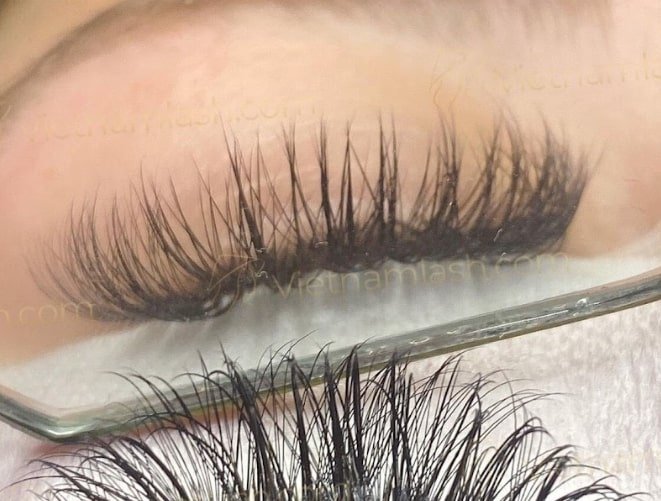 Assessing client’s natural lashes before eyelash extension consultant