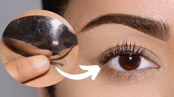 Use a warm spoon to curl your eyelashes